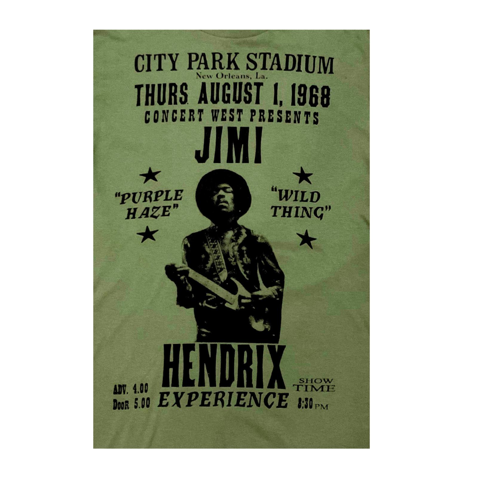 Olive green t-shirt with black text and graphic of Jimi Hendrix, featuring concert details.