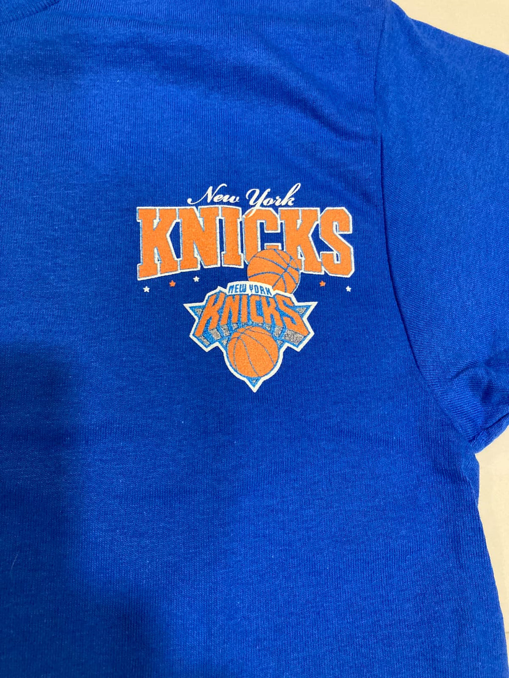 New York Knicks logo on a royal blue t-shirt