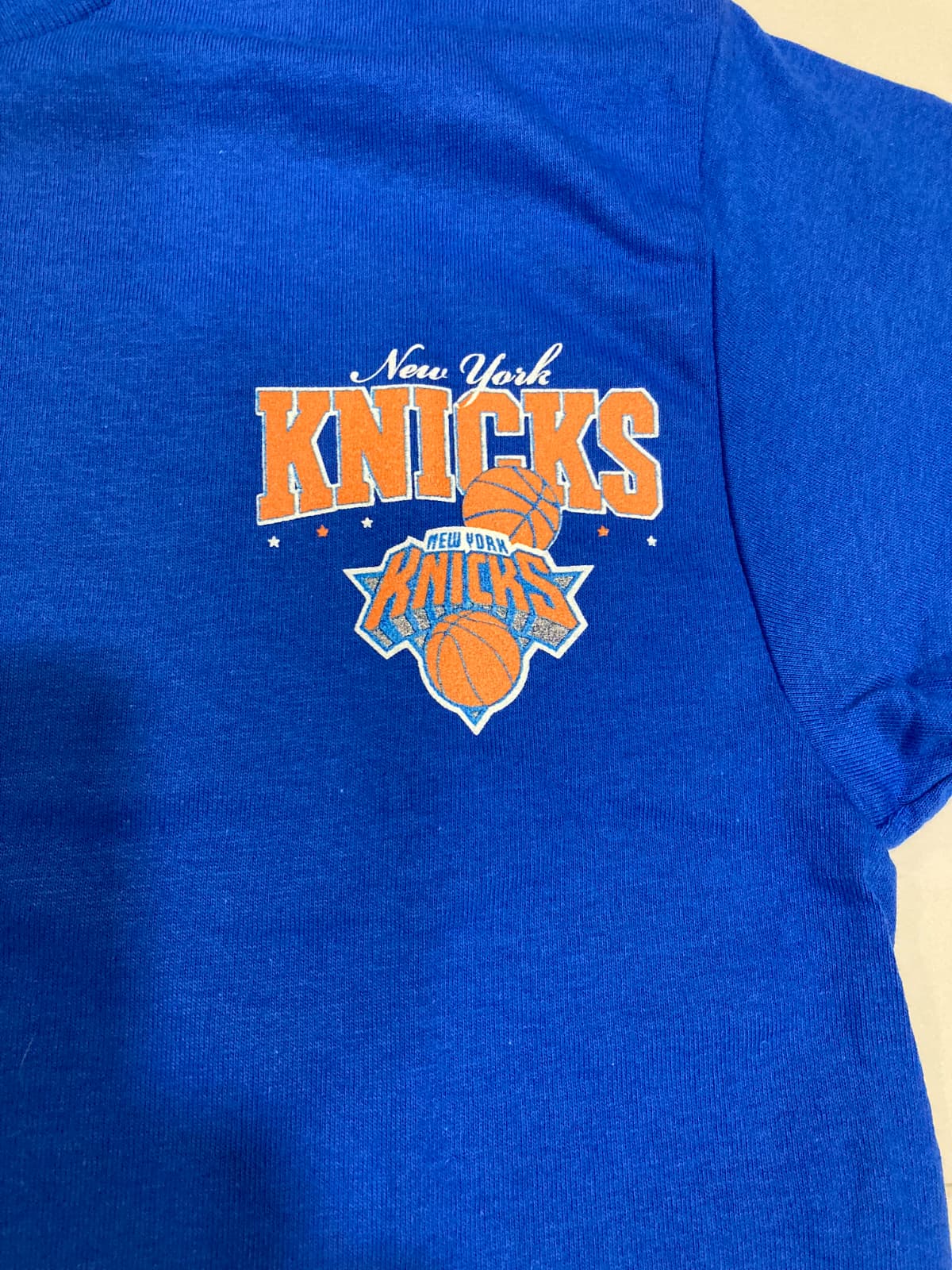 New York Knicks logo on a royal blue t-shirt