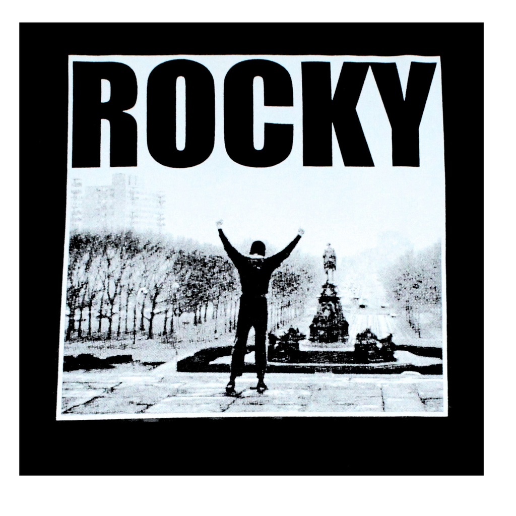 Black and white image of a person with arms outstretched, featuring the word 'ROCKY'.