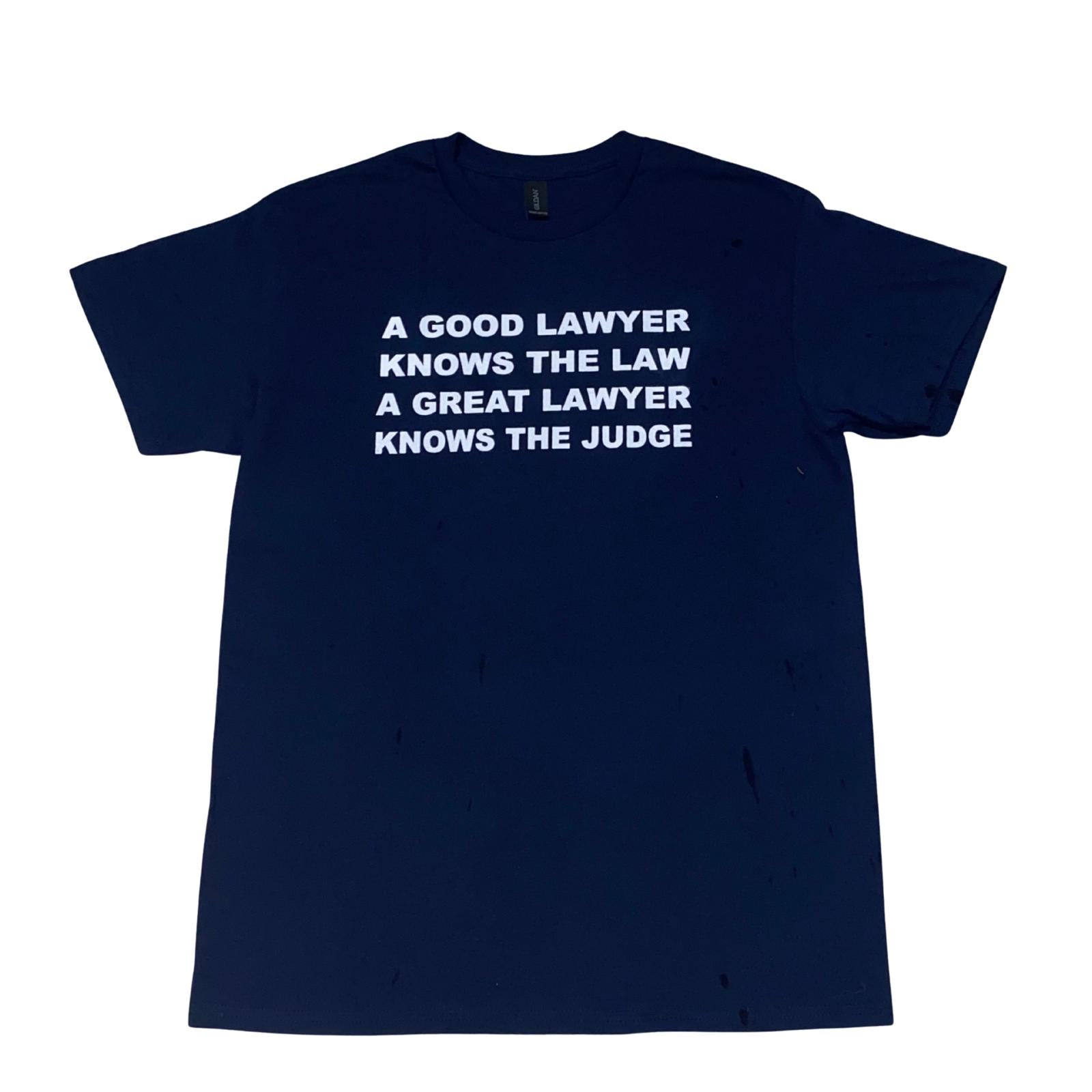 Navy blue t-shirt with white text about lawyers on a white background, round neck shirt, front view