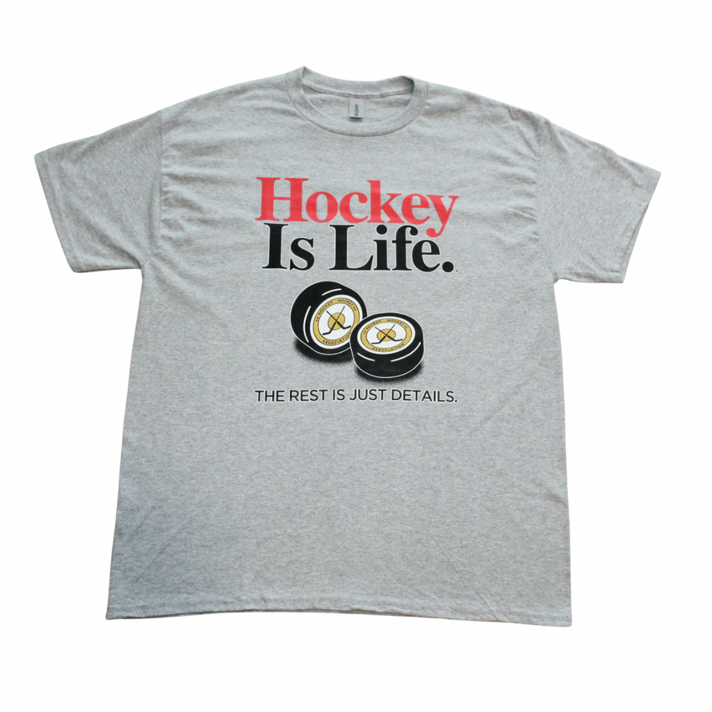 Gray t-shirt with 'Hockey Is Life' text and hockey pucks graphic on a white background