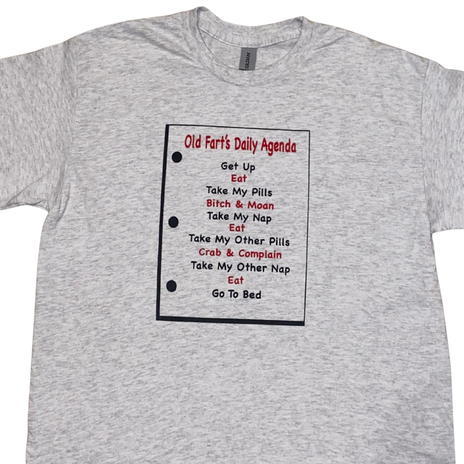 Gray t-shirt with a printed design titled 'Old Fart's Daily Agenda' on a white background.